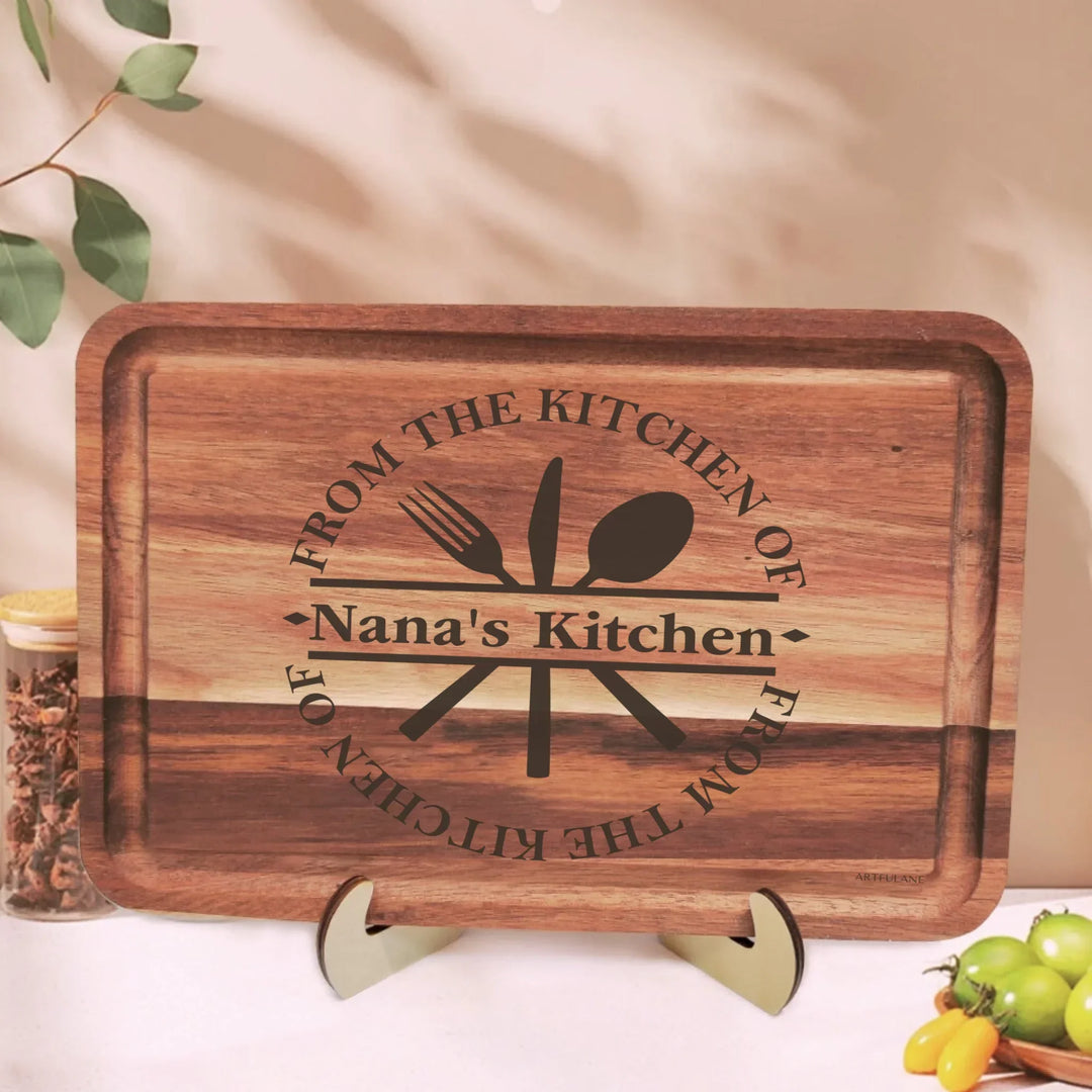 Custom kitchen monogram engraved cutting boards featuring utensils, scrolls, and name designs in walnut and maple wood by ARTFULANE