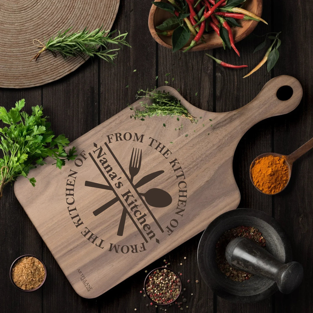 Custom kitchen monogram engraved cutting boards featuring utensils, scrolls, and name designs in walnut and maple wood by ARTFULANE