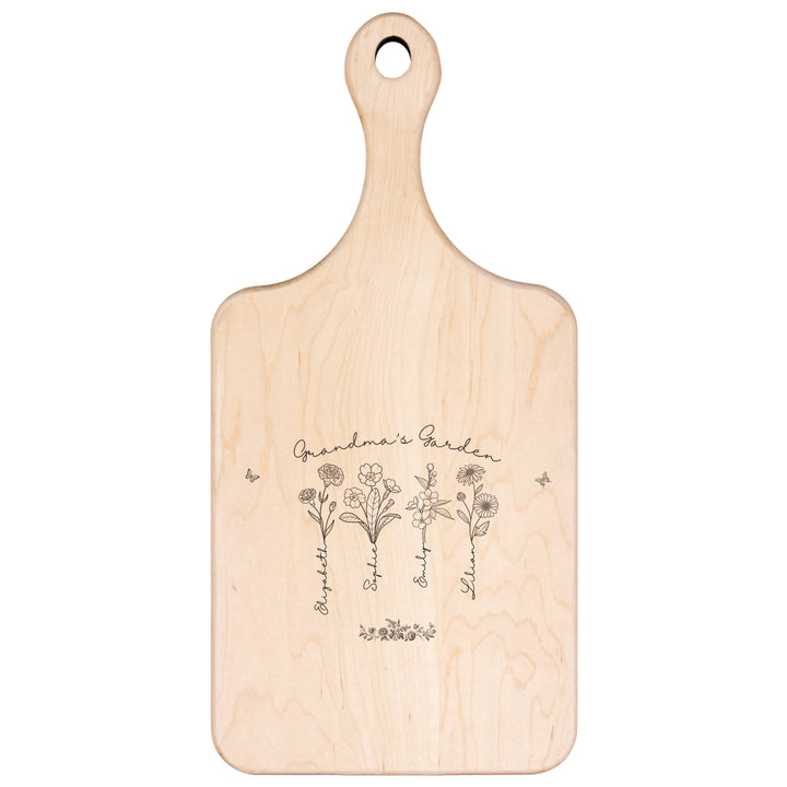 Engraved wooden cutting boards with line art birth month flowers and custom family names in natural maple or walnut finishes by ARTFULANE