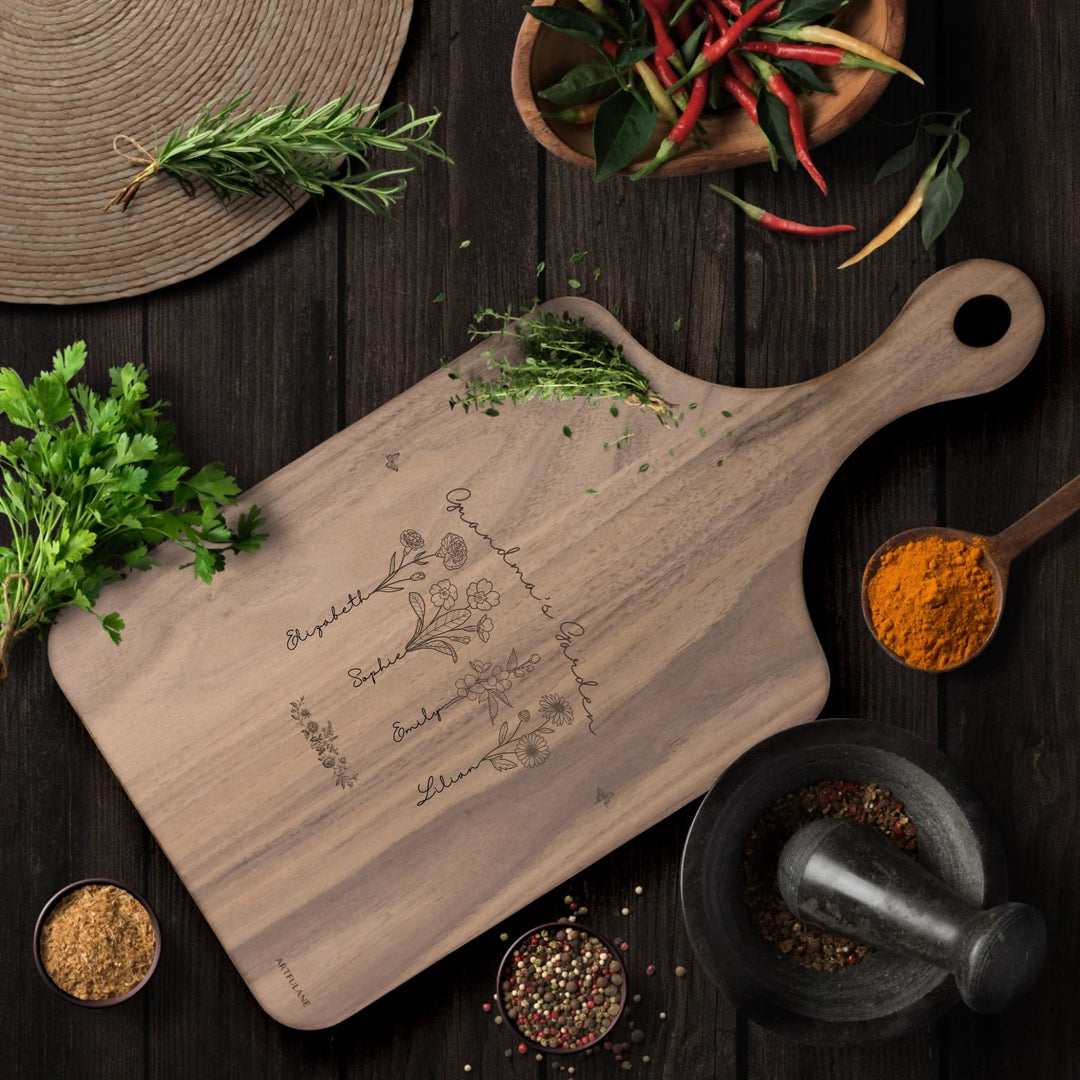 Engraved wooden cutting boards with line art birth month flowers and custom family names in natural maple or walnut finishes by ARTFULANE