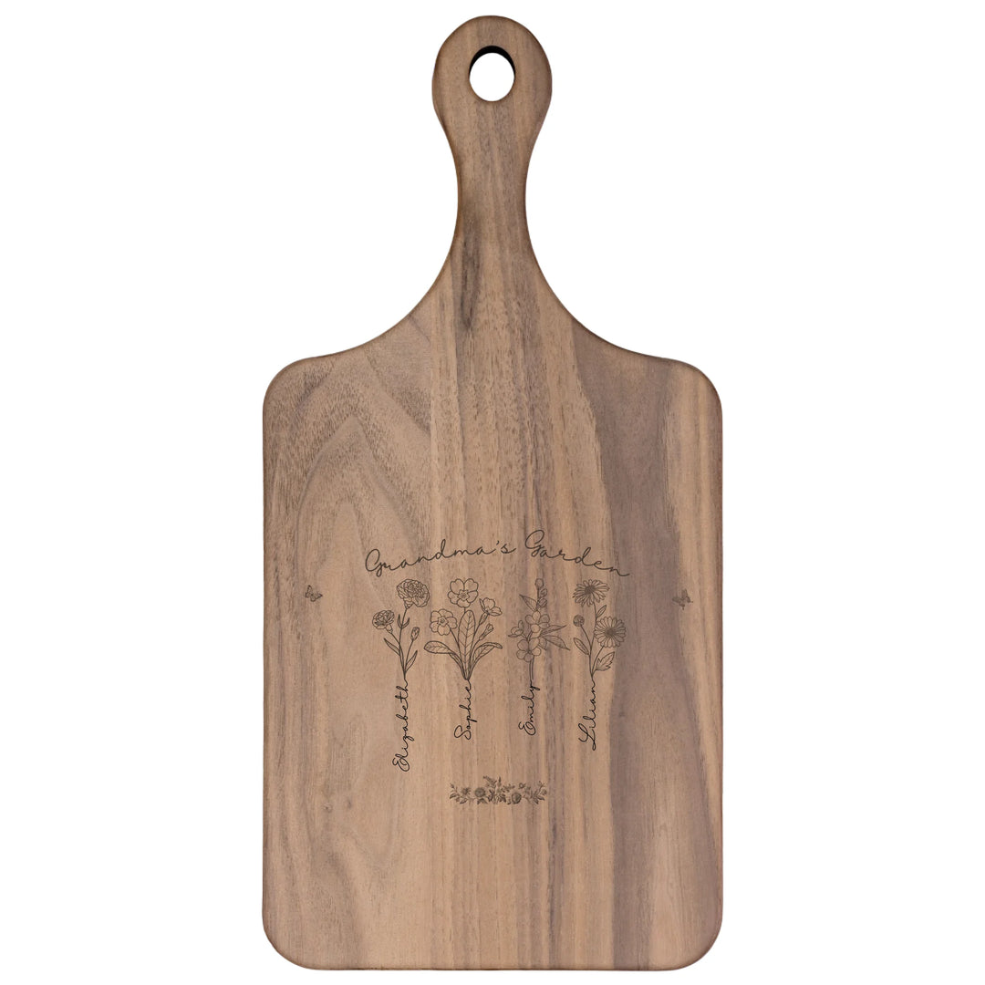 Engraved wooden cutting boards with line art birth month flowers and custom family names in natural maple or walnut finishes by ARTFULANE