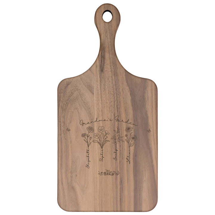 Engraved wooden cutting boards with line art birth month flowers and custom family names in natural maple or walnut finishes by ARTFULANE