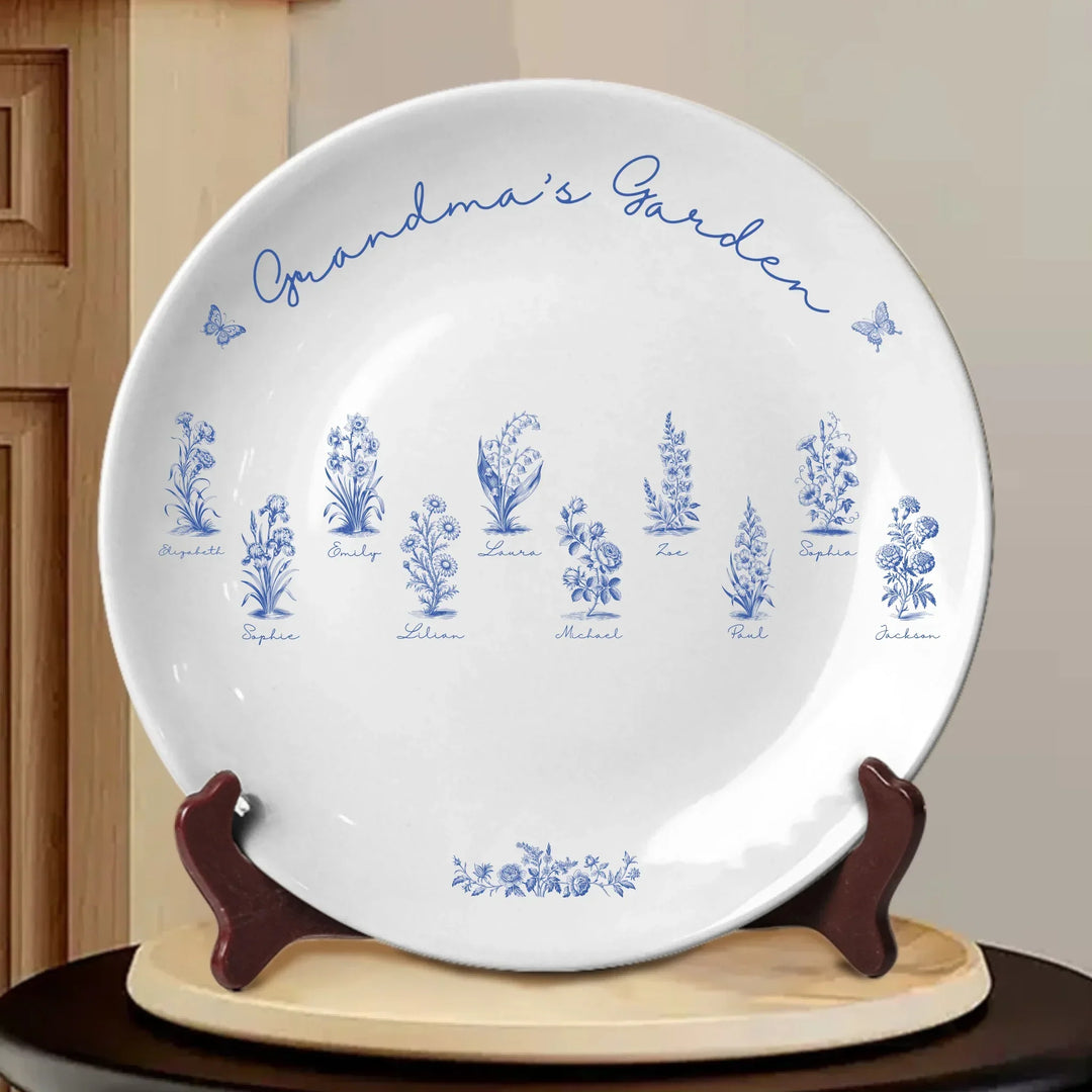 Custom toile birth flower ceramic plate with personalized title, names, butterflies, and floral motifs in any color, displayed on wooden stand-ARTFULANE