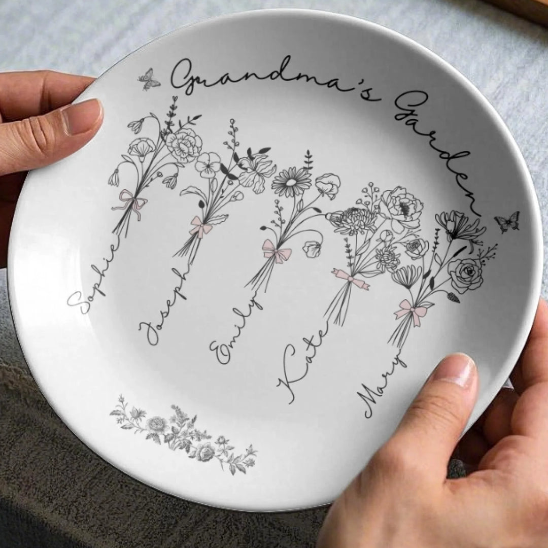 In hands - Custom Coquette birth month flowers ceramic plate with stand featuring delicate floral line art, custom family names, and optional butterflies, available in any color by ARTFULANE