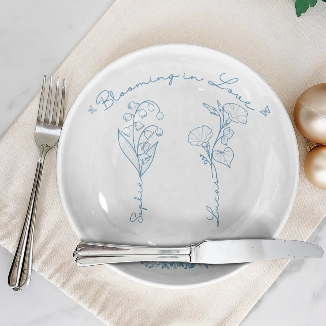 On table - Custom line art birth month flowers ceramic plate with stand featuring names attached to floral stems in any color by ARTFULANE