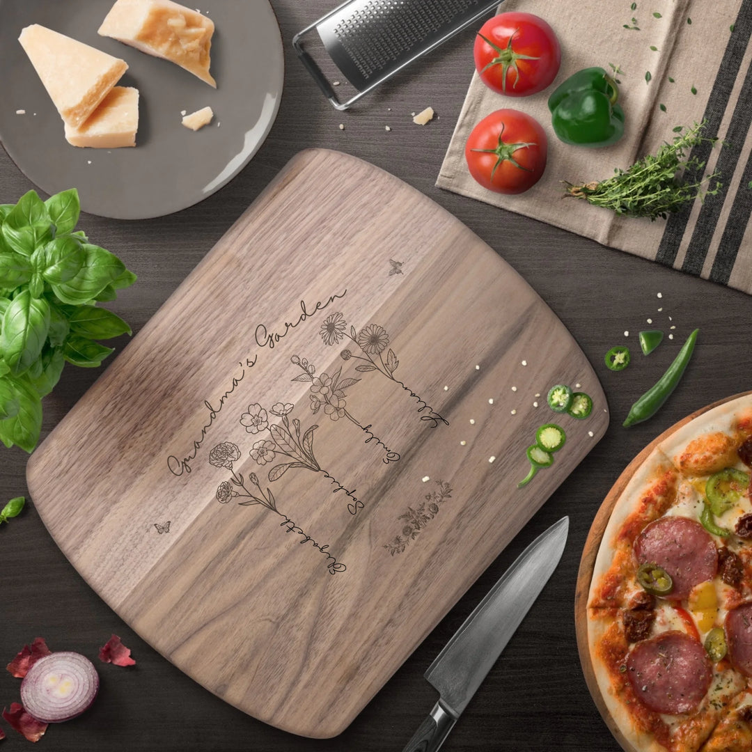 Engraved wooden cutting boards with line art birth month flowers and custom family names in natural maple or walnut finishes by ARTFULANE