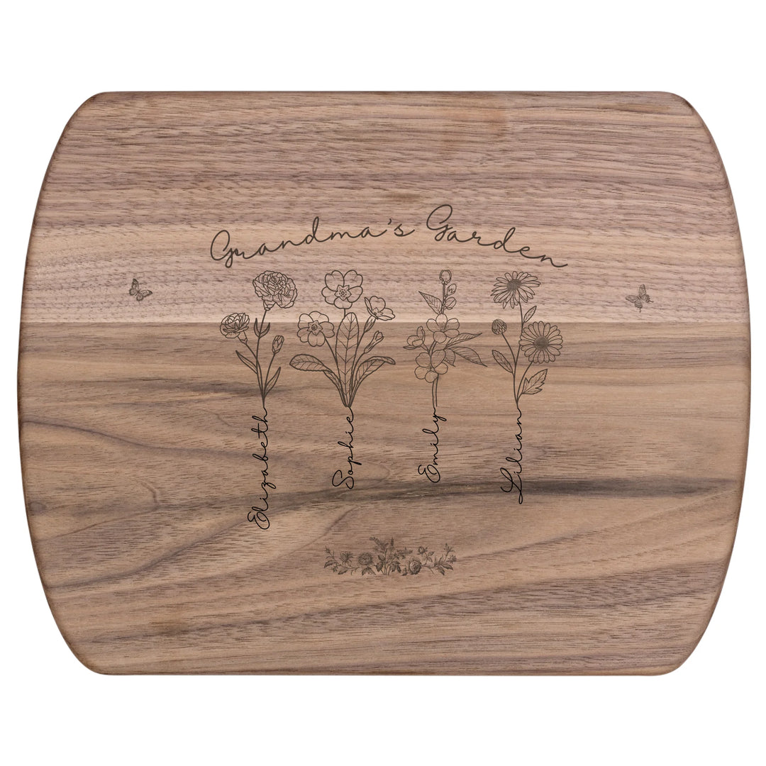 Engraved wooden cutting boards with line art birth month flowers and custom family names in natural maple or walnut finishes by ARTFULANE