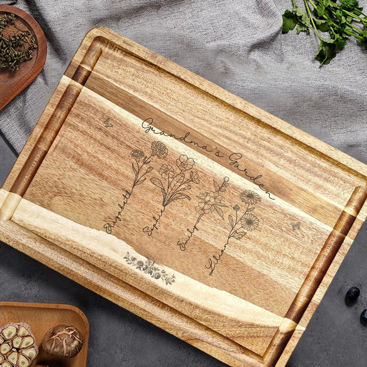 Engraved wooden cutting boards with line art birth month flowers and custom family names in natural maple or walnut finishes by ARTFULANE