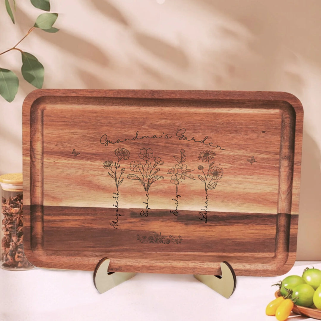 Engraved wooden cutting boards with line art birth month flowers and custom family names in natural maple or walnut finishes by ARTFULANE
