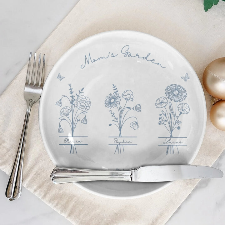 On table - Custom Monogram birth flower line art ceramic plate with stand in any color featuring minimalist floral designs and custom family names by ARTFULANE