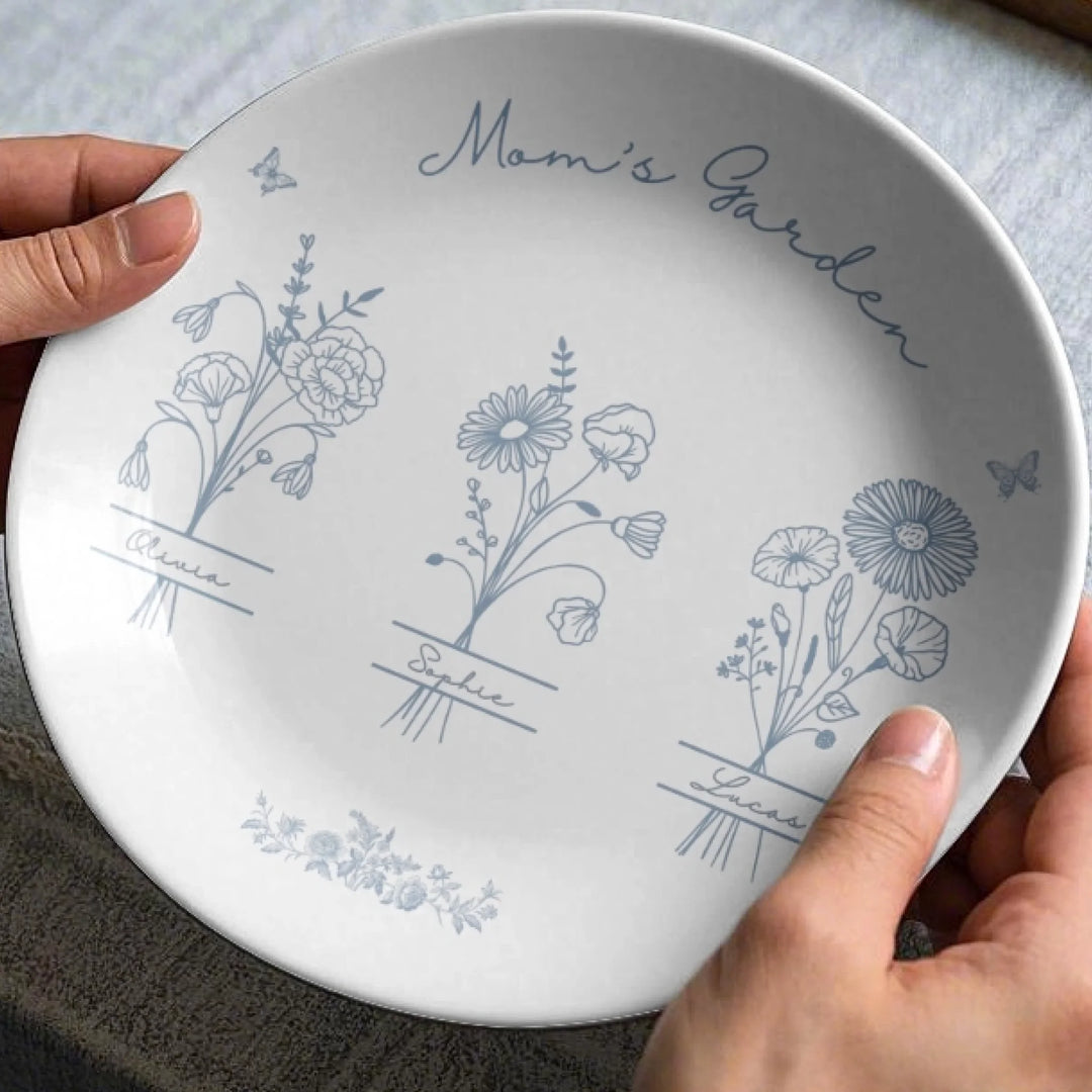 In hands - Custom Monogram birth flower line art ceramic plate with stand in any color featuring minimalist floral designs and custom family names by ARTFULANE