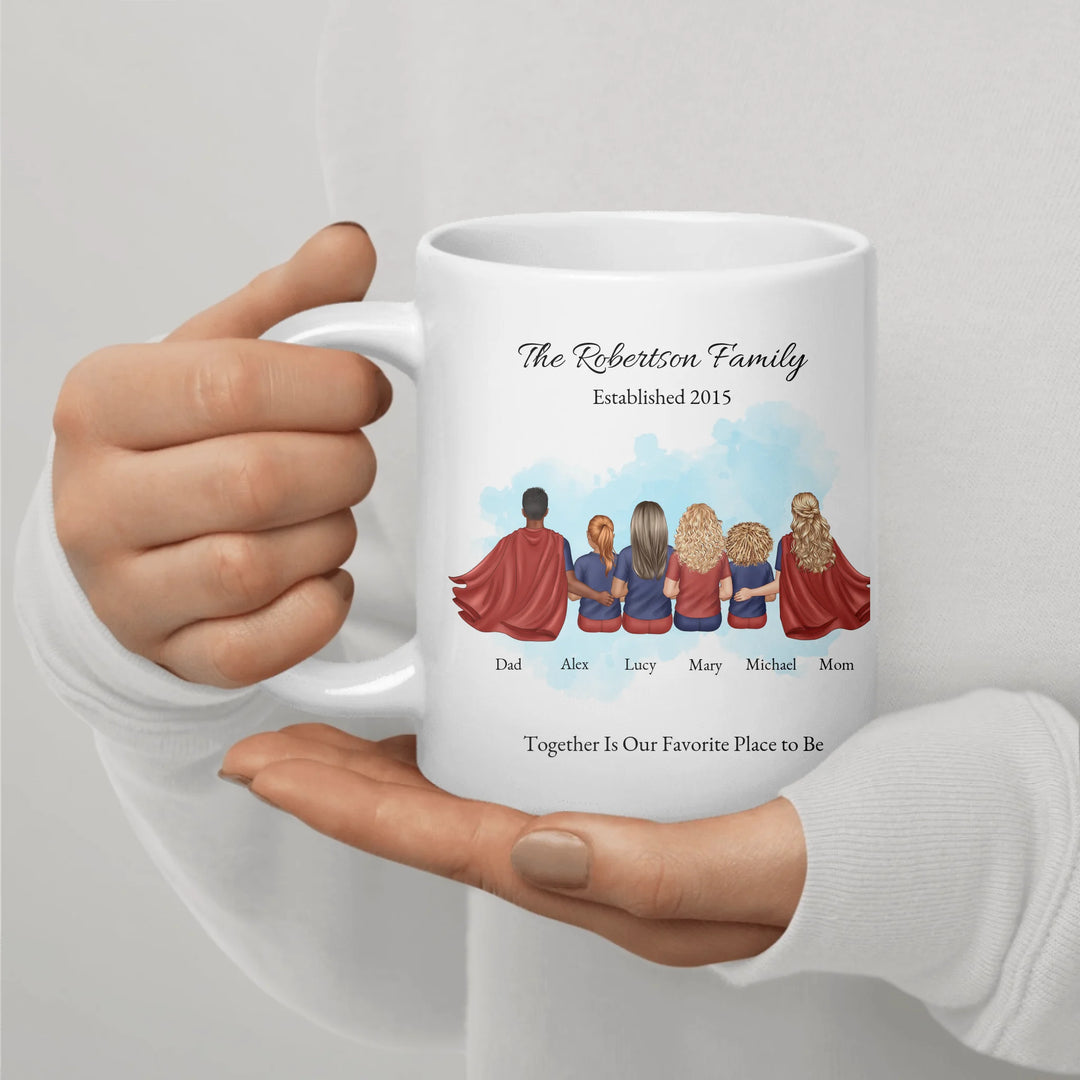 Personalized superhero family mug with matching outfits and names, seated back view -ceramic mug in hand-ARTFULANE