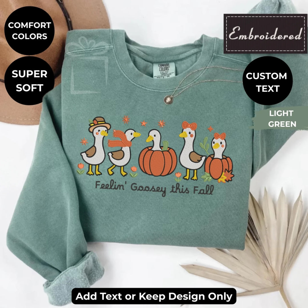 Fall Geese Sweatshirt in light green – Comfort Colors embroidered crewneck with geese and pumpkin design, customizable text option-ARTFULANE