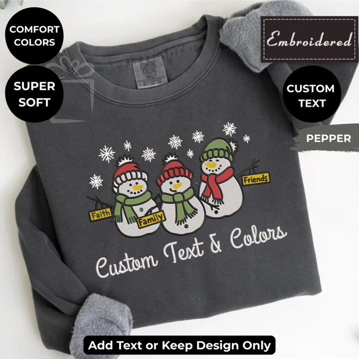 Comfort Colors sweatshirt featuring trio snowmen Faith Family Friends embroidered design – customizable holiday crewneck-ARTFULANE