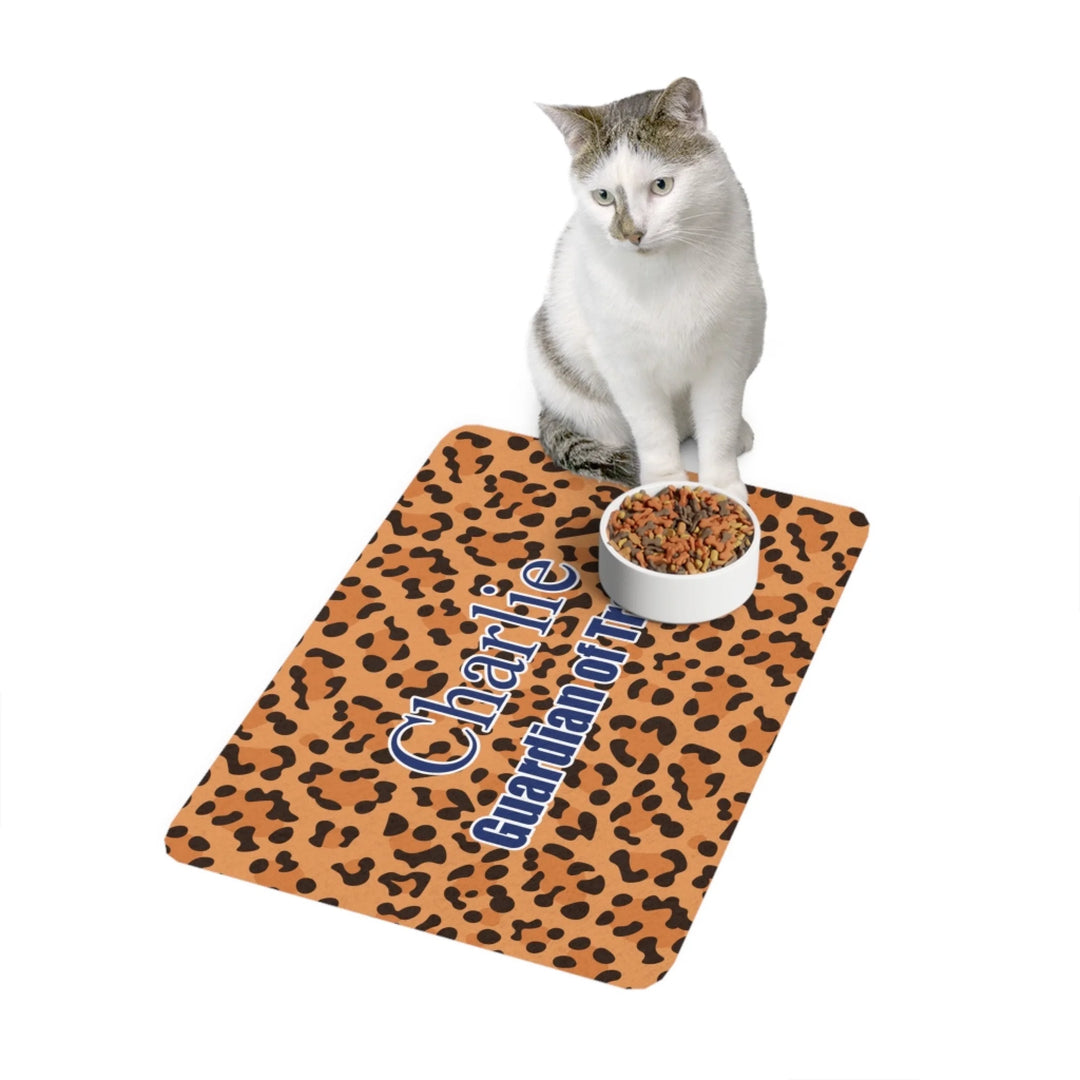 Cat using Personalized Animal Print pet feeding mat with custom text like a name. Available in different animal print colors (leopard, cow, snake, crocodile, cheetah, dalmatian, giraffe, zebra, tiger, scales) for dogs or cats-ARTFULANE