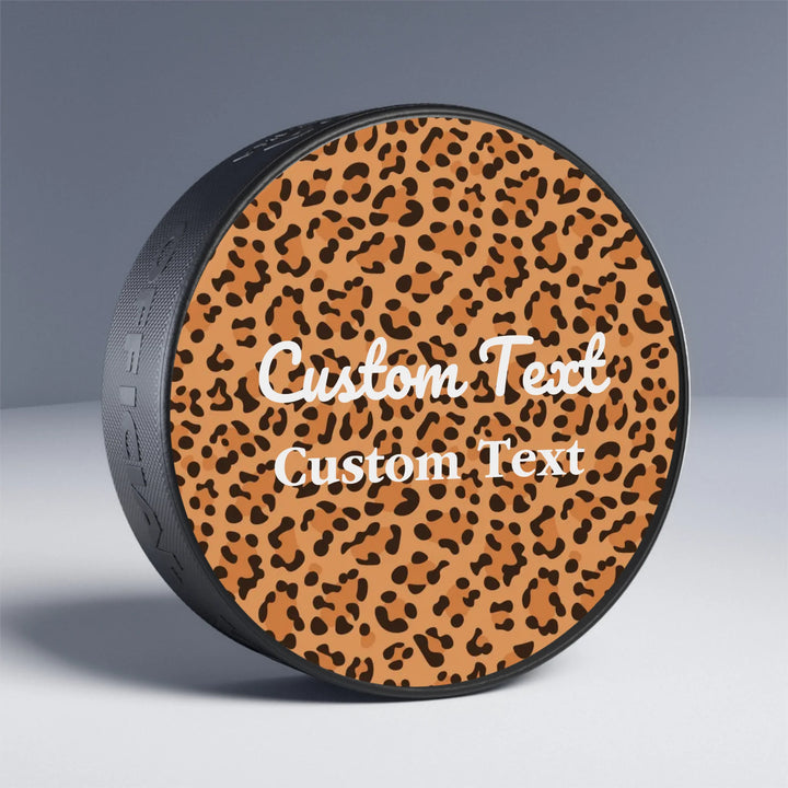 Custom animal print hockey puck featuring bold leopard, zebra, tiger patterns, and more — personalized sports gear for athletes and sport lovers by ARTFULANE.
