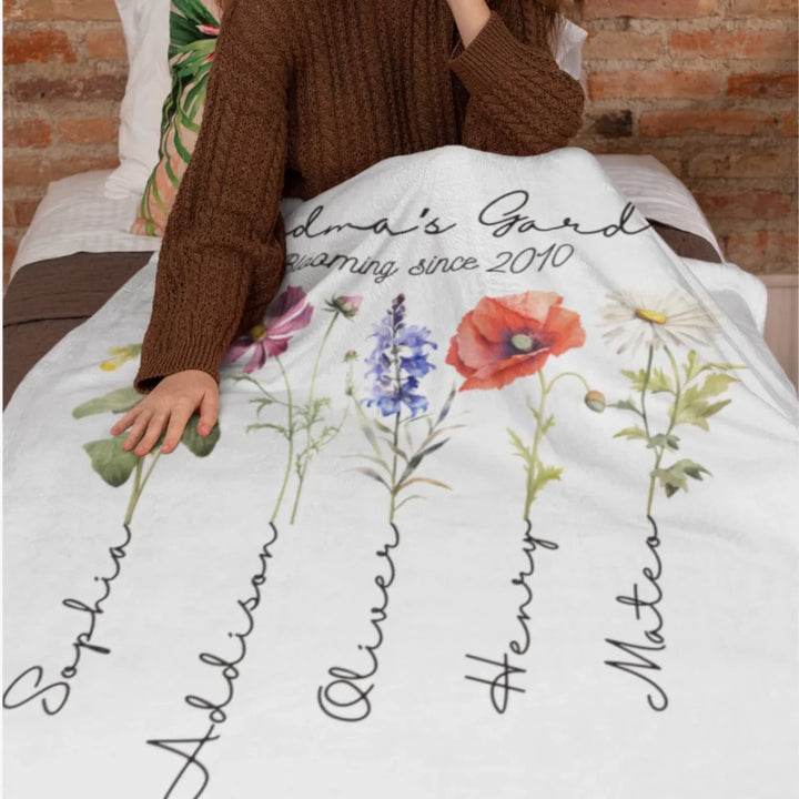 Woman-Covered-With-Custom-Watercolor-Birth-Month-Flower-Garden-Blanket-artfulane