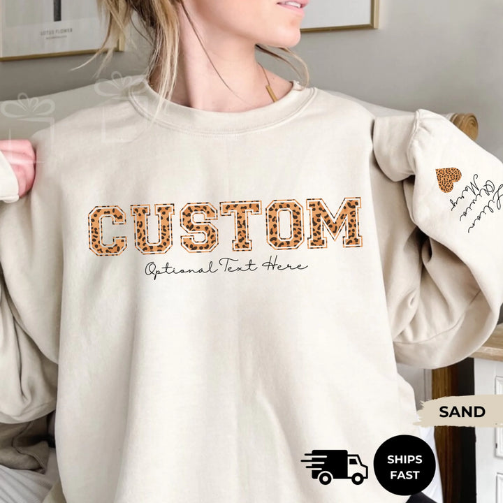 Personalized ‘This Mama Loves Her Blessings’ Gildan sweatshirt or hoodie, featuring custom kids names printed below gift box icons on the sleeve — cozy unisex holiday apparel for moms or grandmas-ARTFULANE