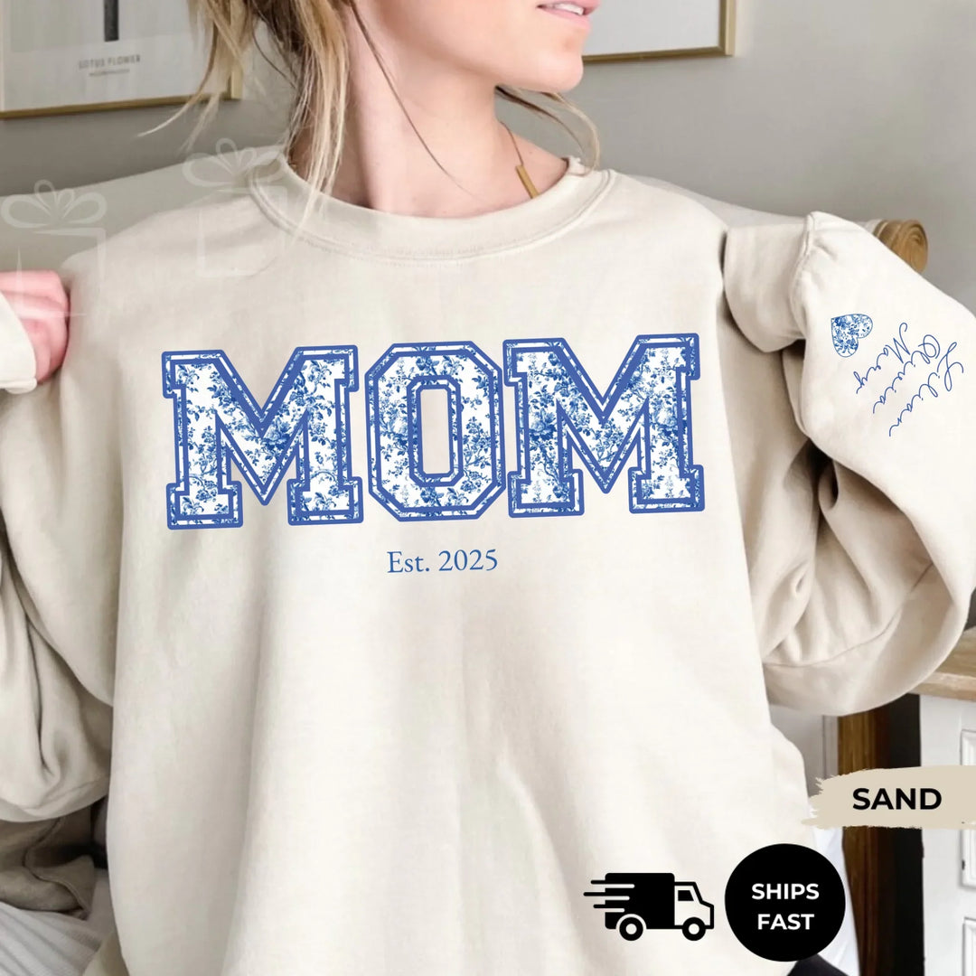 Personalized ‘This Mama Loves Her Blessings’ Gildan sweatshirt or hoodie, featuring custom kids names printed below gift box icons on the sleeve — cozy unisex holiday apparel for moms or grandmas-ARTFULANE