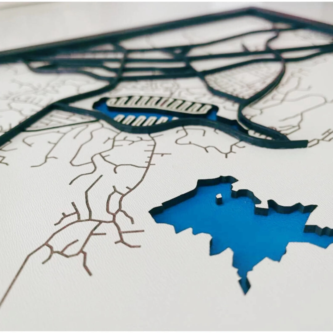 Close-up of four-layer custom wooden map showing painted water, engraved land, and cut street details-ARTFULANE