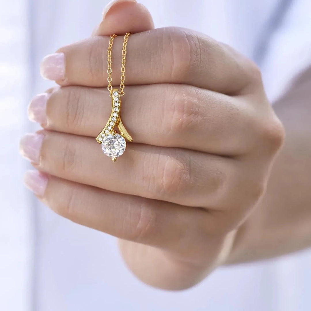 Cubic-Zirconia-Ribbon-Pendant-Necklace-yellow-gold-in-hand-artfulane