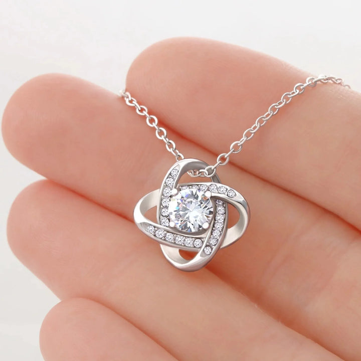 Custom-Love-Knot-Necklace-in-hand-artfulane