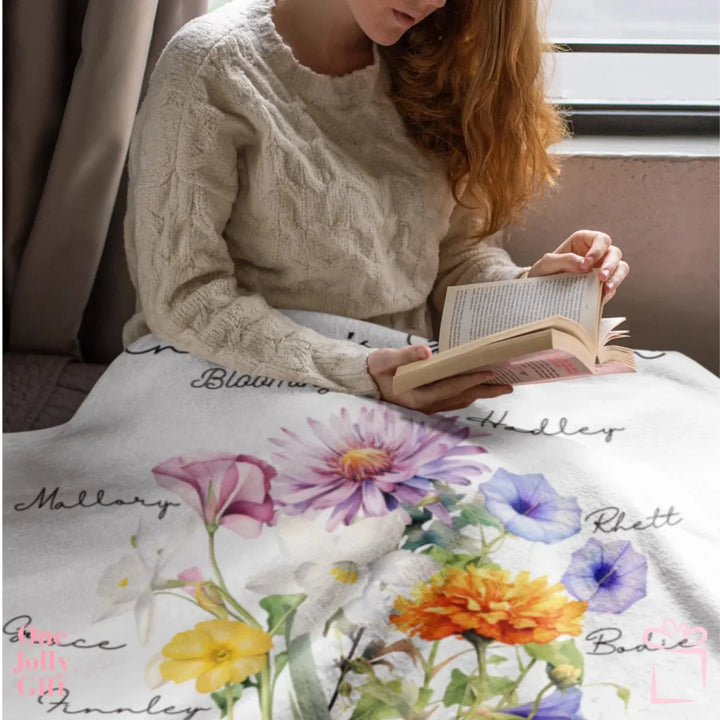woman-sitting-with-Custom-Watercolor-Birth-Month-Flower-bouquet-Blanket-artfulane