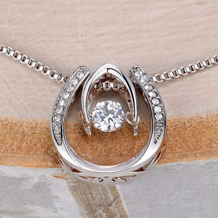 Dancing-Cubic-Zirconia-Pendant-Necklace-on-table-artfulane